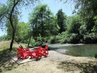 Adirondack chairs along the river at Truett-Hurst